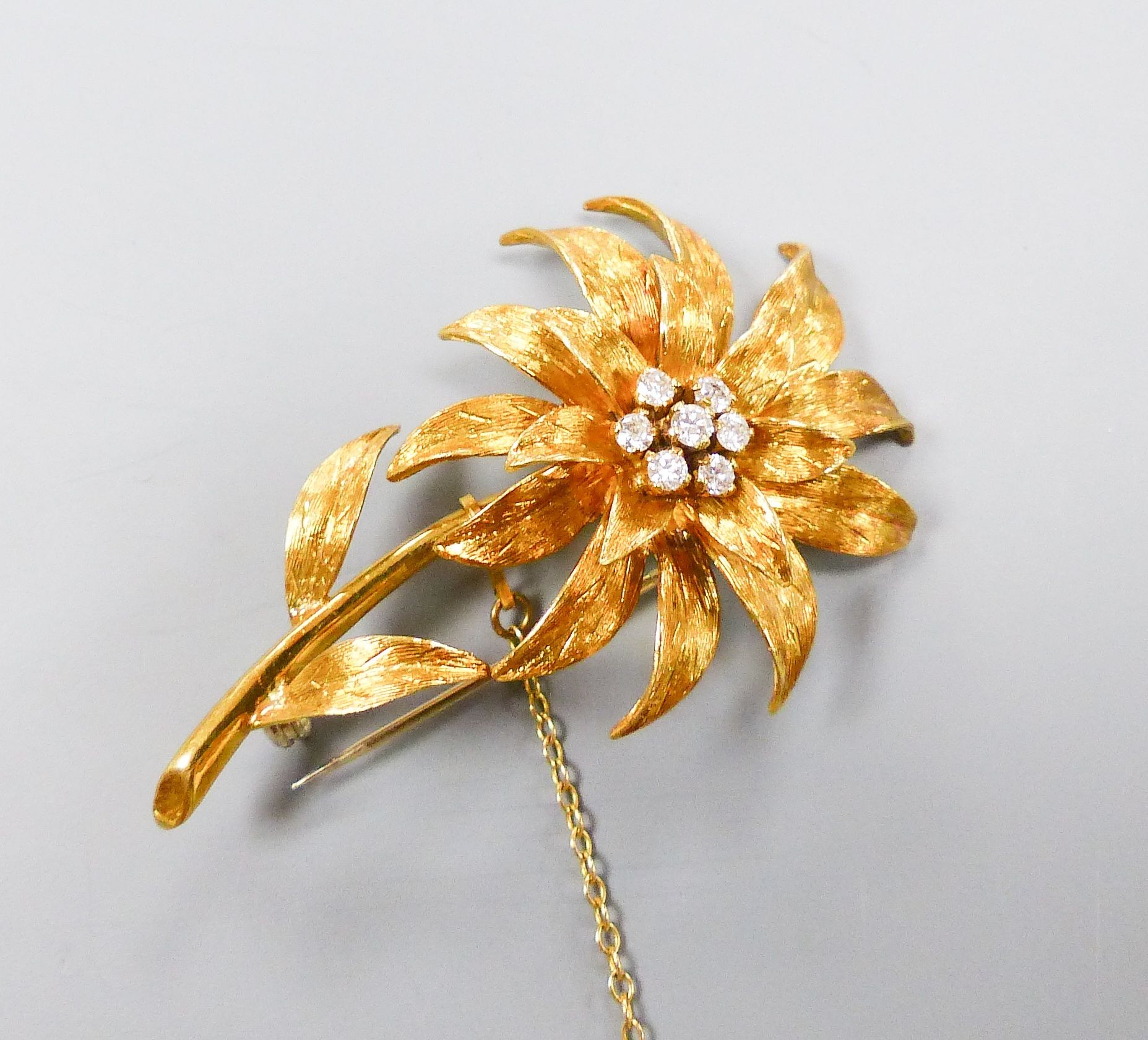 An early 1970's 18ct gold and seven stone diamond set flower brooch, by Cropp & Farr, London, 1972, 52mm.